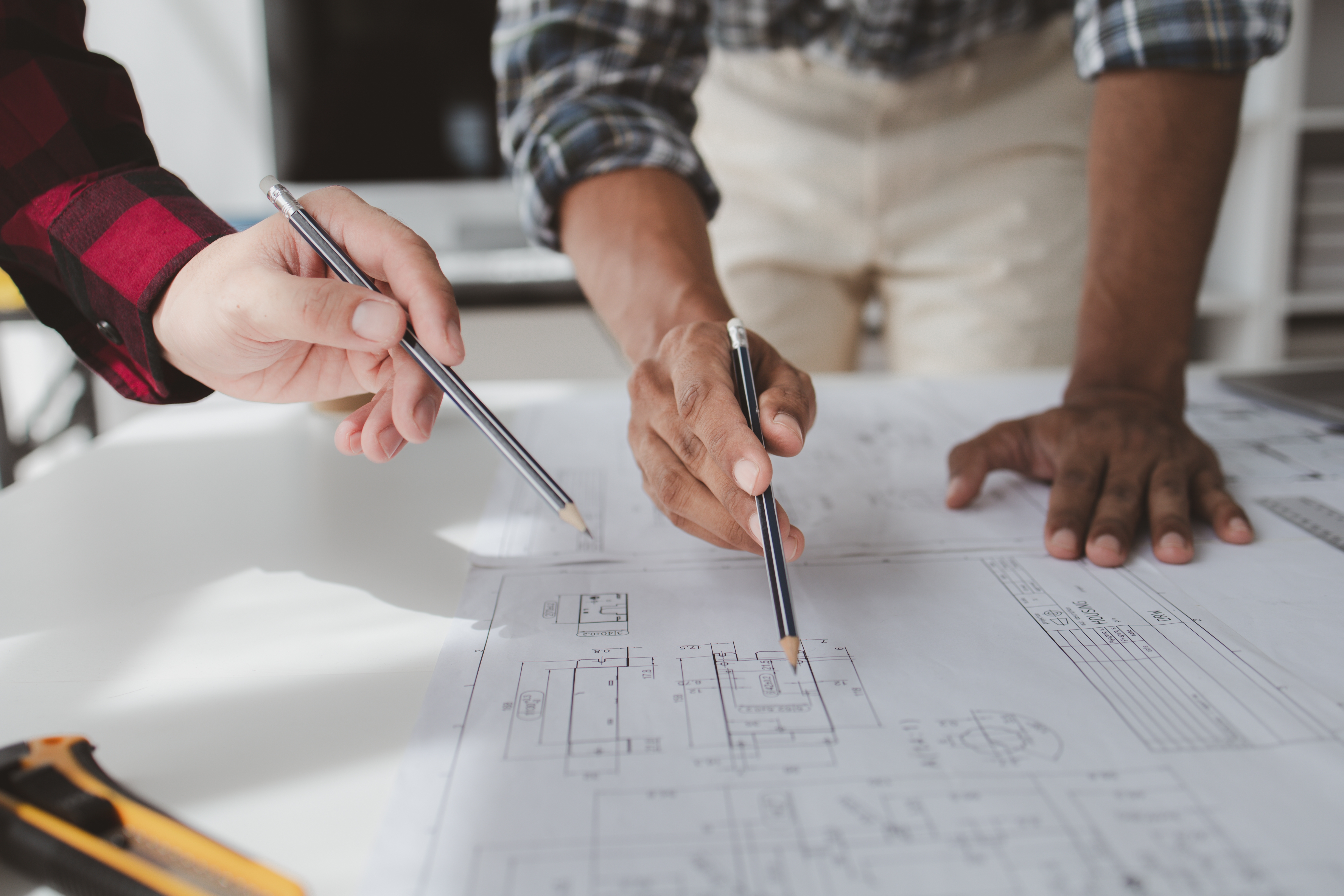 Technology planning consultation with professionals reviewing property plans
