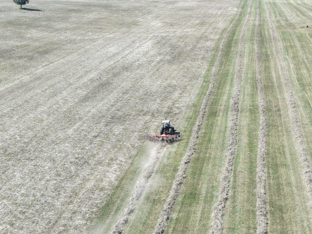 Aerial photograph of a tractor working in a harvested hay field in Central Kentucky.